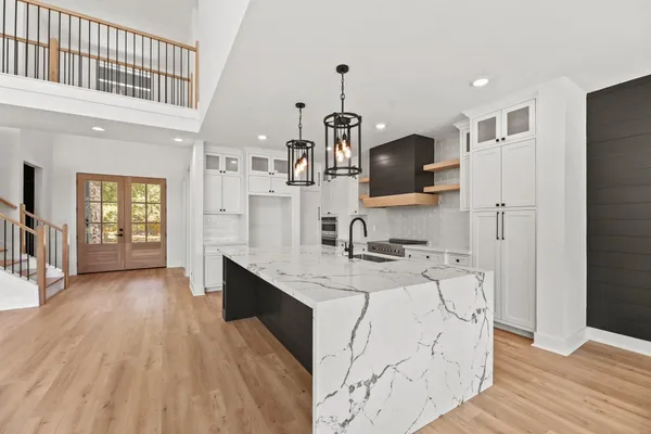 a kitchen with a sink stove and refrigerator