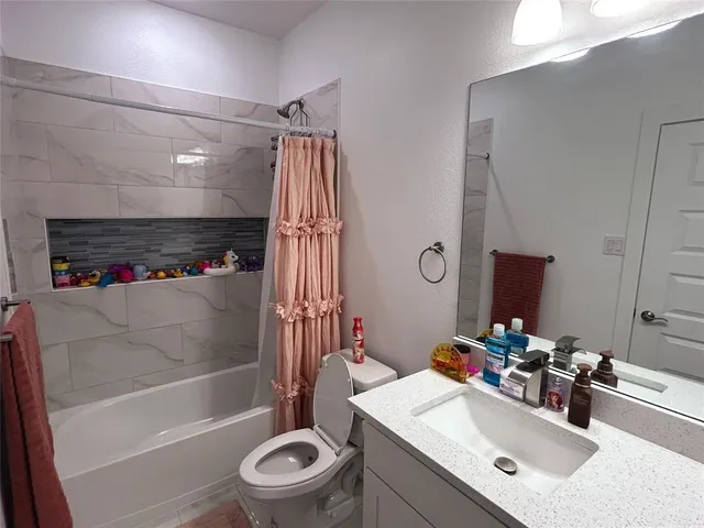 a bathroom with a sink mirror toilet and bathtub