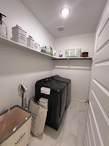a utility room with sink dryer and washer