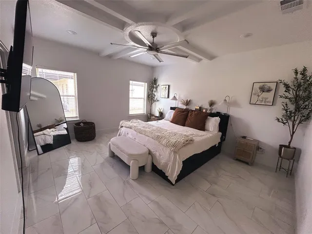 a bedroom with a bed couch and window