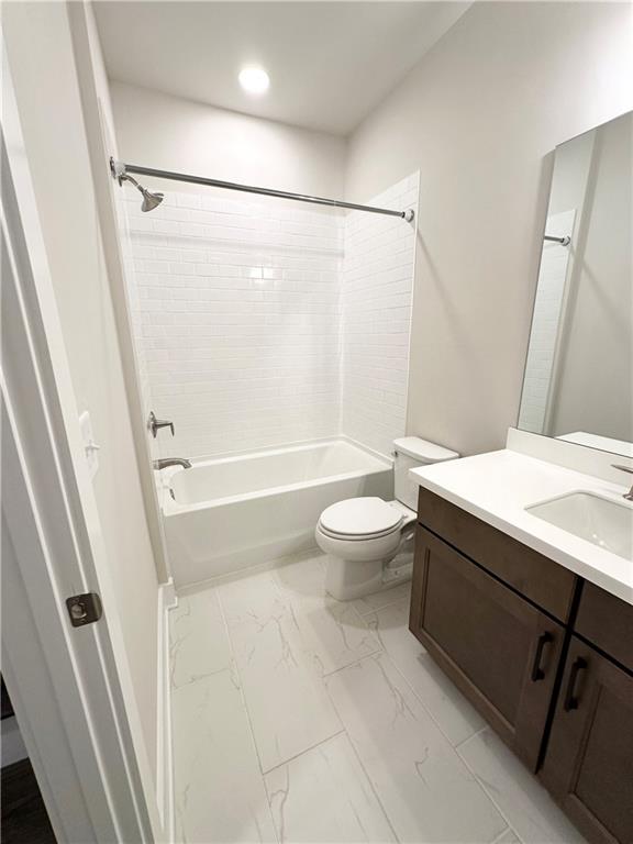 1237 Waldon Crossing Cumming, GA 30041 - Photo 20 of 29 a bathroom with a sink a toilet a mirror and a bathtub