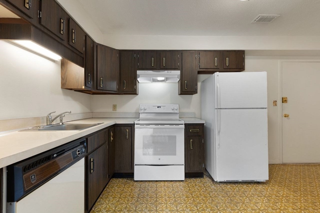 1008 Paradise Road, Unit 2Q Swampscott, MA 01907 - Photo 13 of 25 a kitchen with a refrigerator and a sink