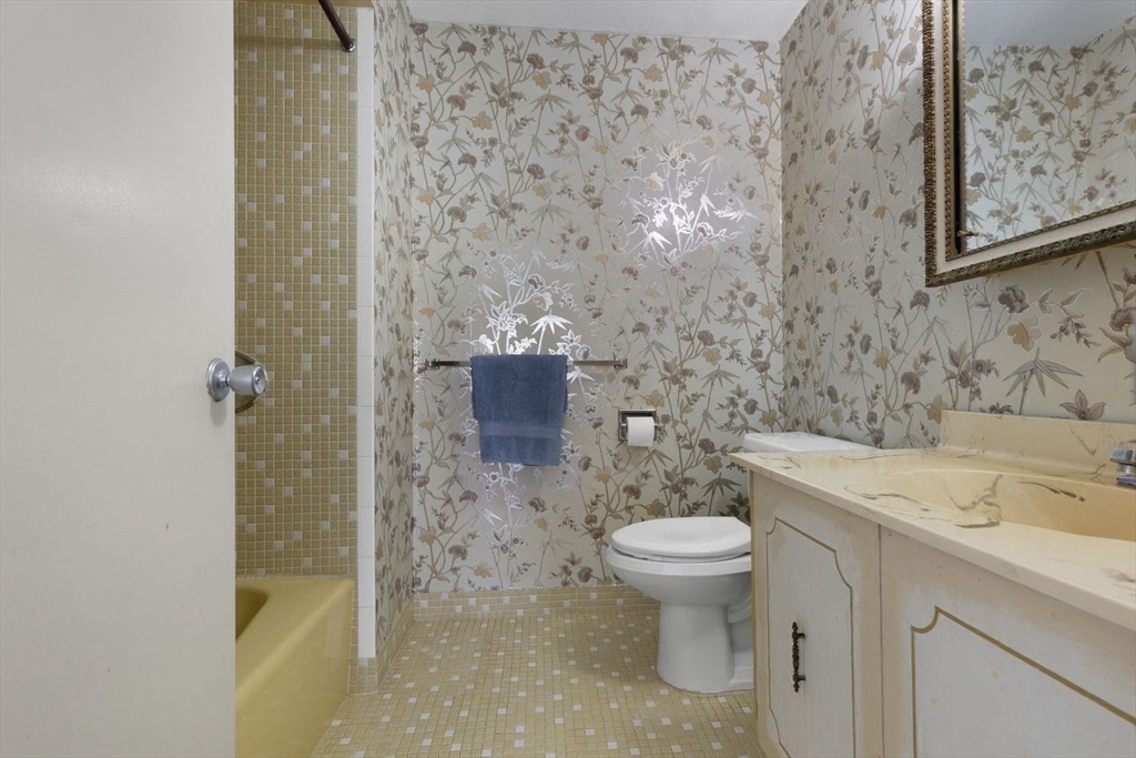 1008 Paradise Road, Unit 2Q Swampscott, MA 01907 - Photo 15 of 25 a bathroom with a granite countertop toilet and a sink