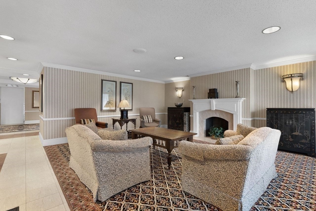 1008 Paradise Road, Unit 2Q Swampscott, MA 01907 - Photo 4 of 25 a living room with furniture a fireplace and a table