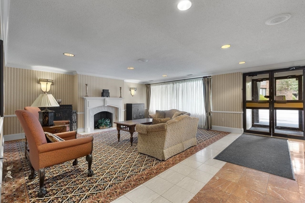 1008 Paradise Road, Unit 2Q Swampscott, MA 01907 - Photo 5 of 25 a living room with furniture a fireplace and a floor to ceiling window
