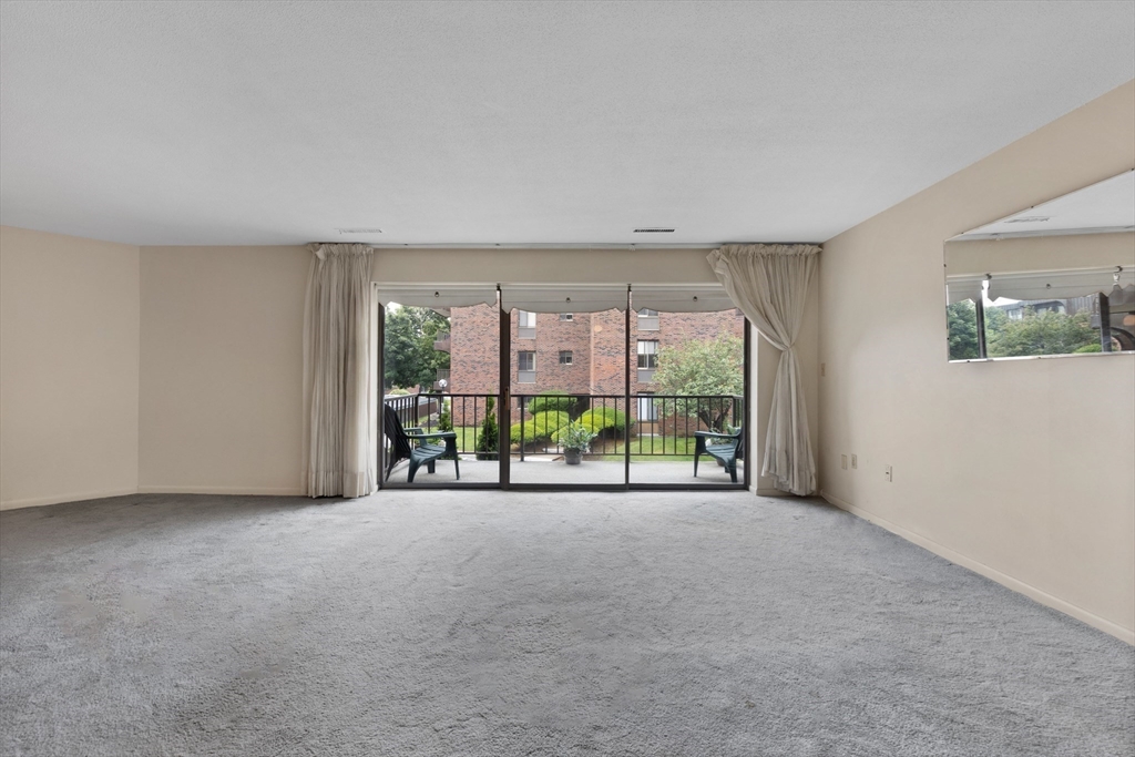 1008 Paradise Road, Unit 2Q Swampscott, MA 01907 - Photo 8 of 25 a view of an empty room with windows