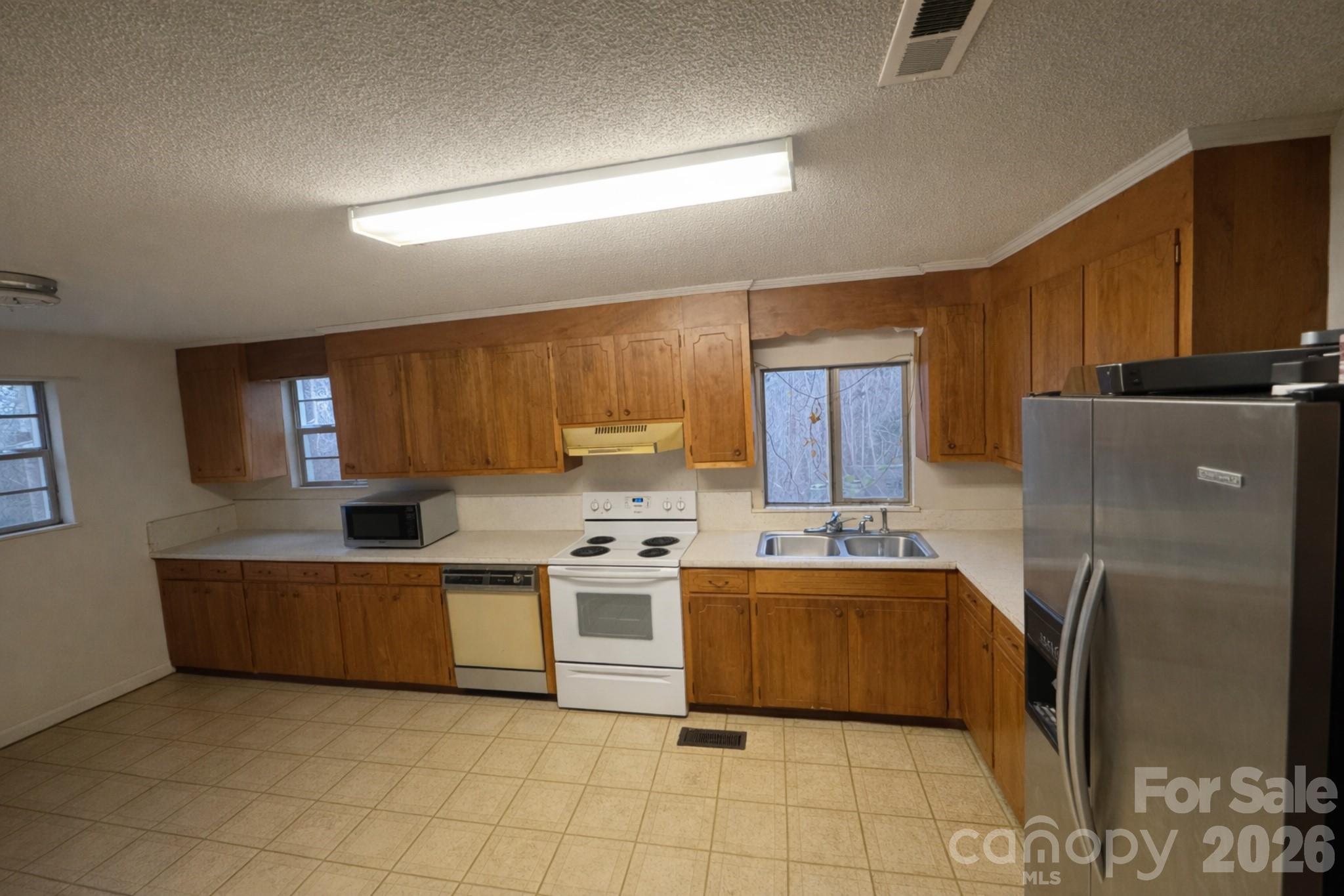 2112 New Prospect Church Road Shelby, NC 28150 - Photo 7 of 9 a kitchen with stainless steel appliances a stove a refrigerator sink and cabinets