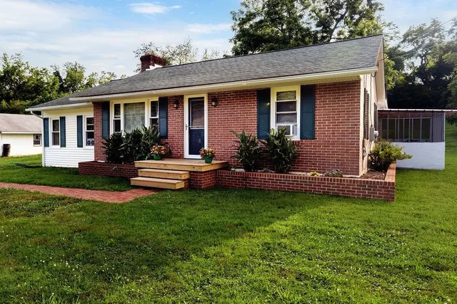a front view of house with yard and green space