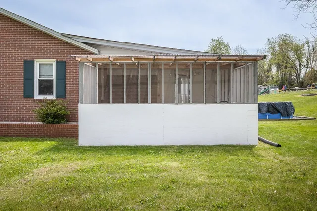 a view of a backyard with potted plants and wooden fence
