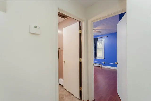 a view of a hallway with wooden floor