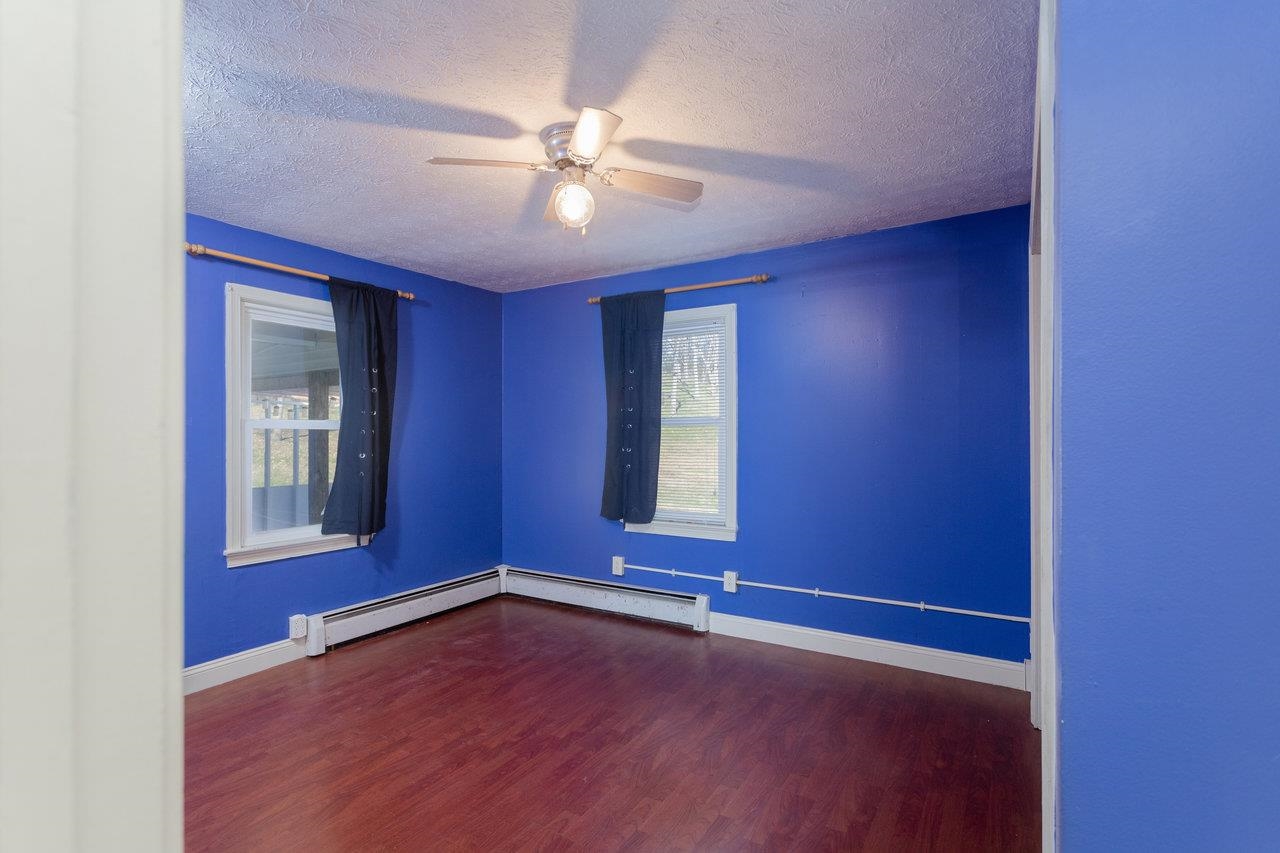 911 Old White Hill Road Stuarts Draft, VA 24477 - Photo 19 of 40 a view of an empty room with window and wooden floor
