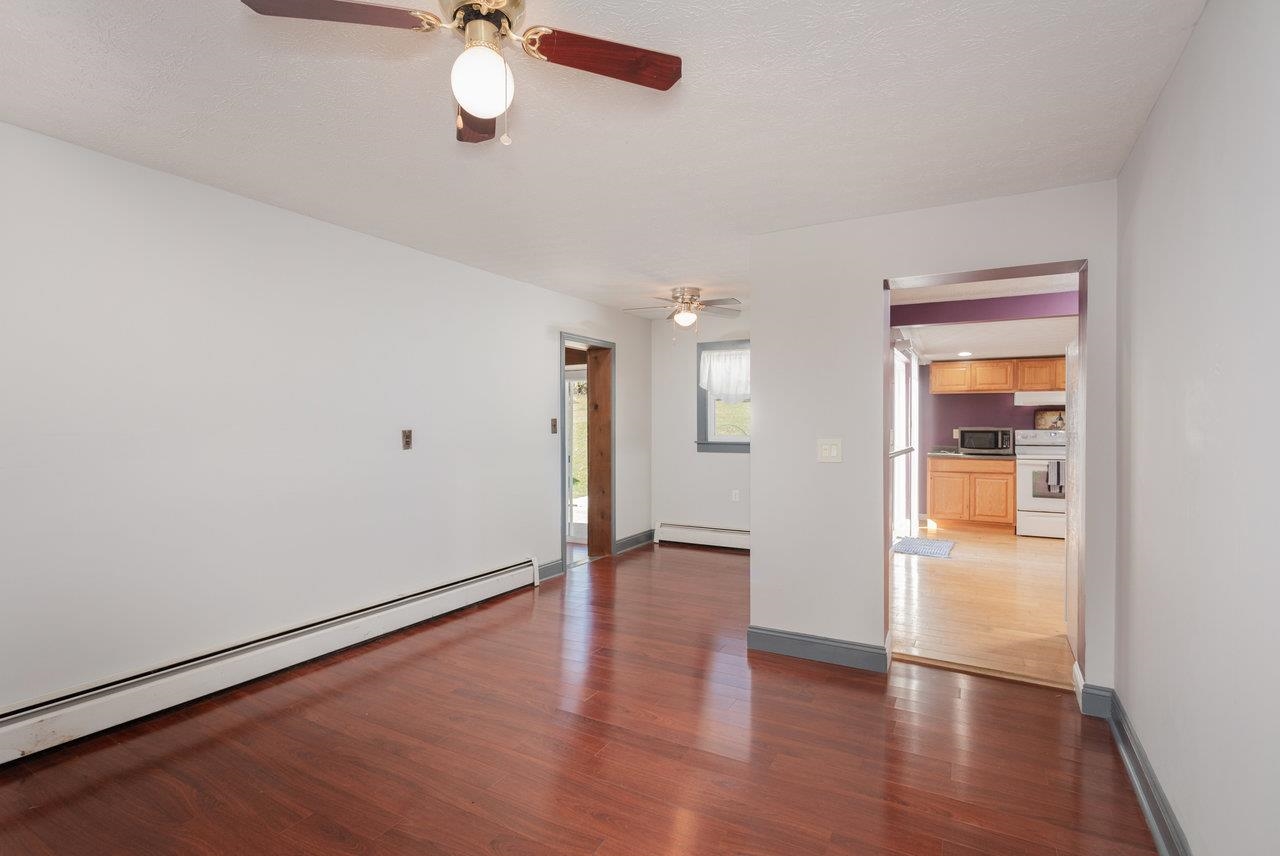 911 Old White Hill Road Stuarts Draft, VA 24477 - Photo 23 of 40 a view of an empty room with wooden floor and a window