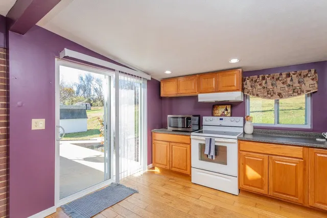 a kitchen with stainless steel appliances granite countertop wooden cabinets a sink and dishwasher