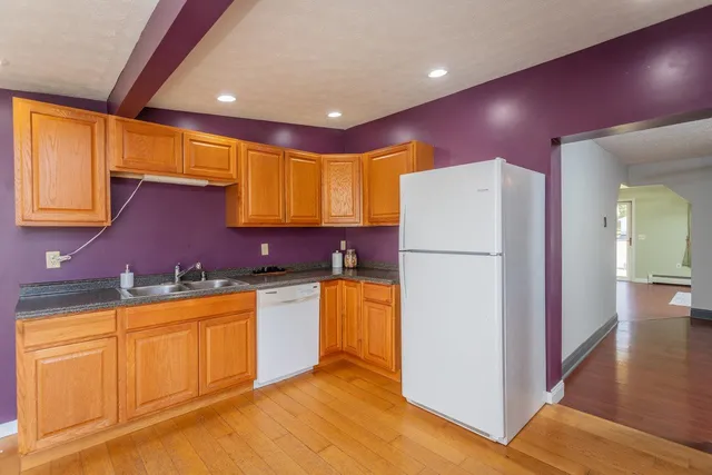 a kitchen with a refrigerator a sink and a stove