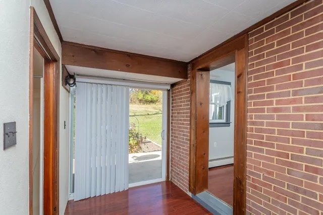 a bathroom with a toilet a sink and a window