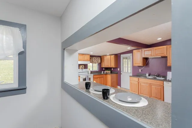 a kitchen with stainless steel appliances a sink and a stove