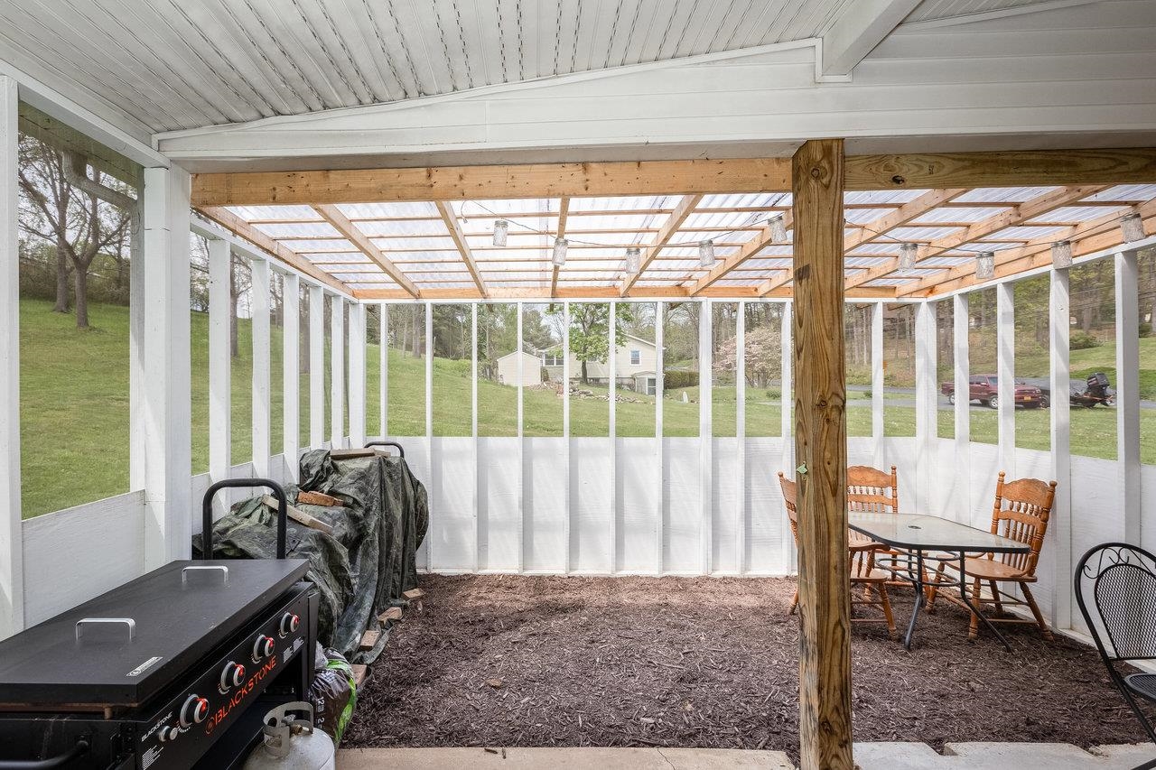 911 Old White Hill Road Stuarts Draft, VA 24477 - Photo 6 of 40 a bed sitting in a room next to a window