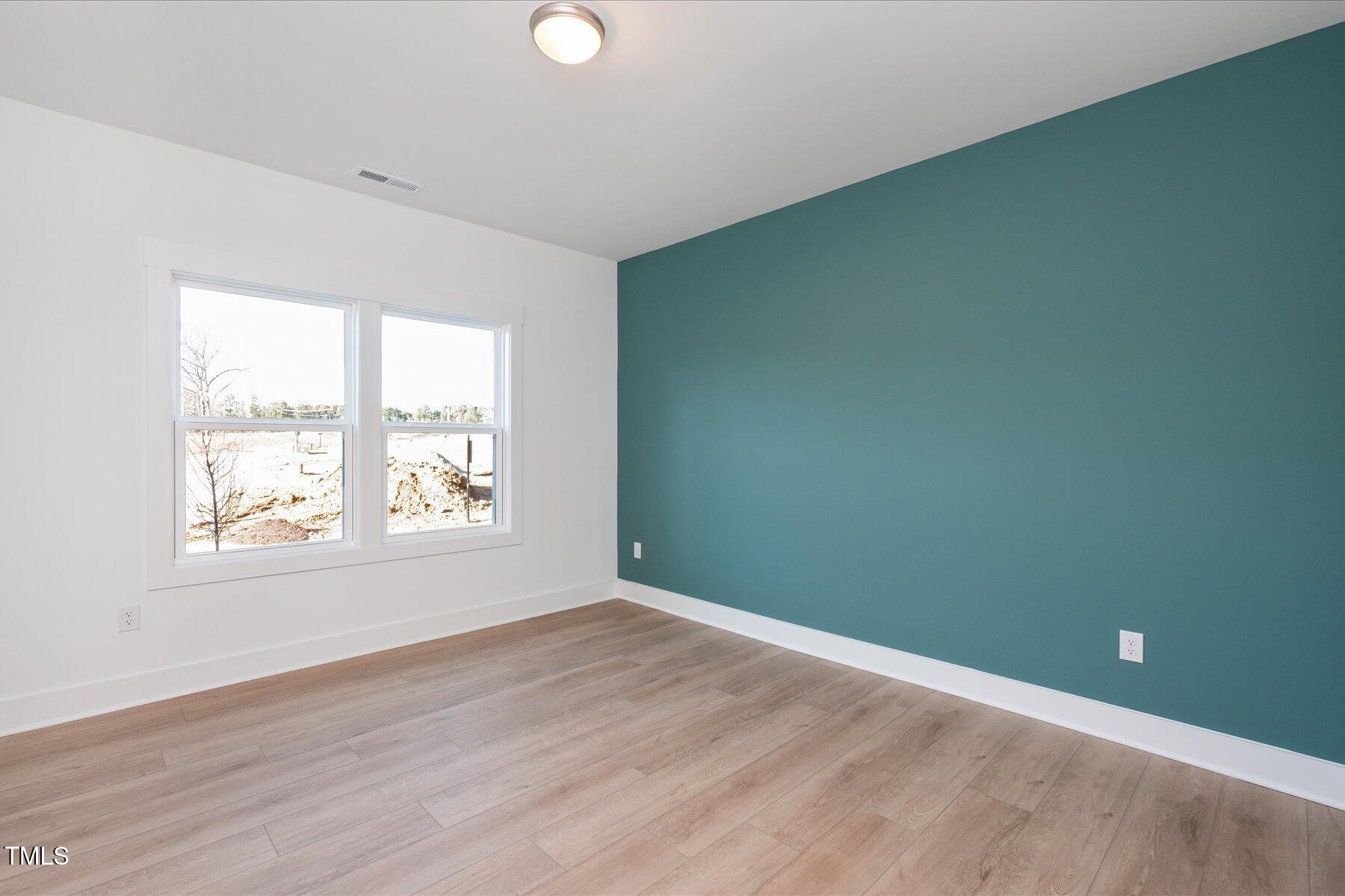 3939 Willow Gate Way Raleigh, NC 27604 - Photo 20 of 32 an empty room with wooden floor and windows