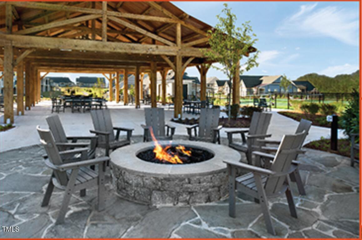 3939 Willow Gate Way Raleigh, NC 27604 - Photo 28 of 32 a patio with a table and chairs and a potted plant