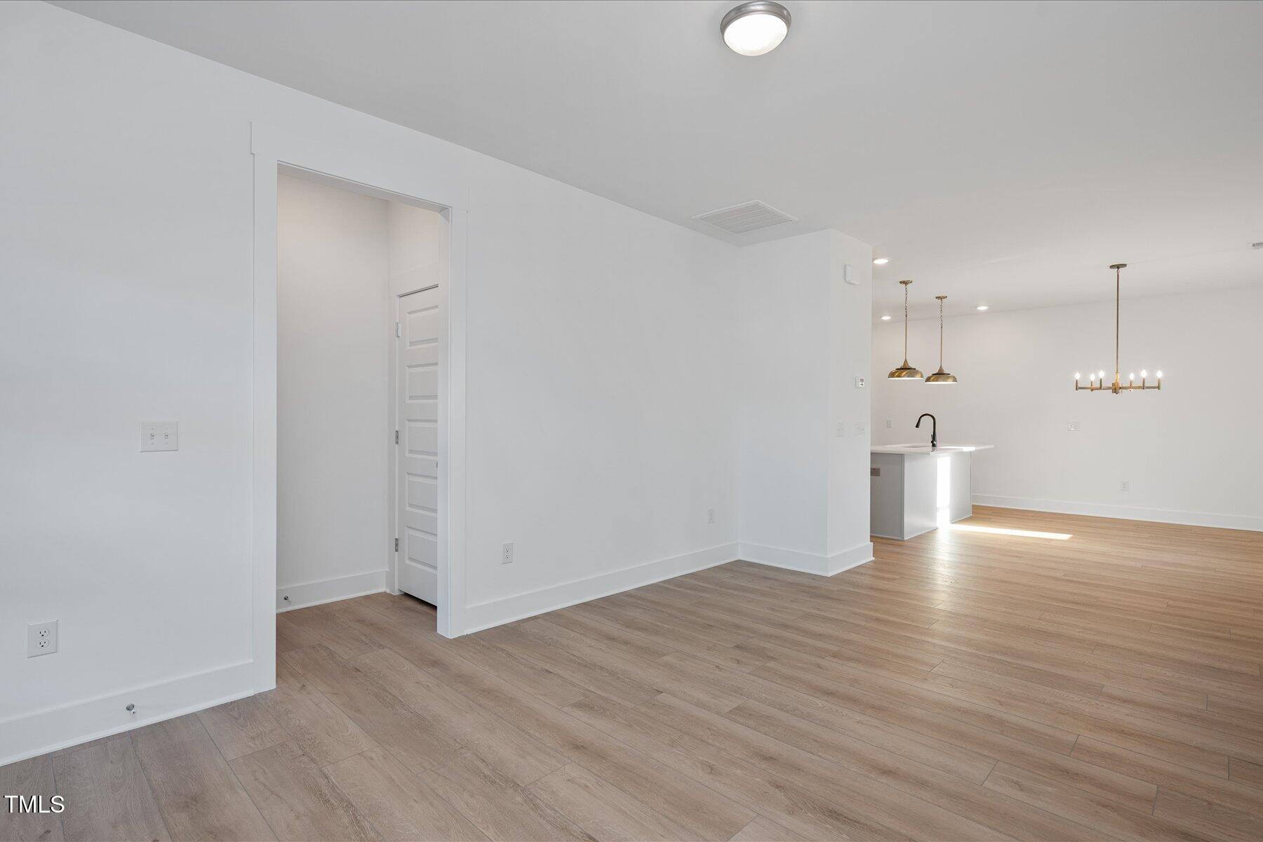 3939 Willow Gate Way Raleigh, NC 27604 - Photo 4 of 32 a view of empty room with wooden floor and window