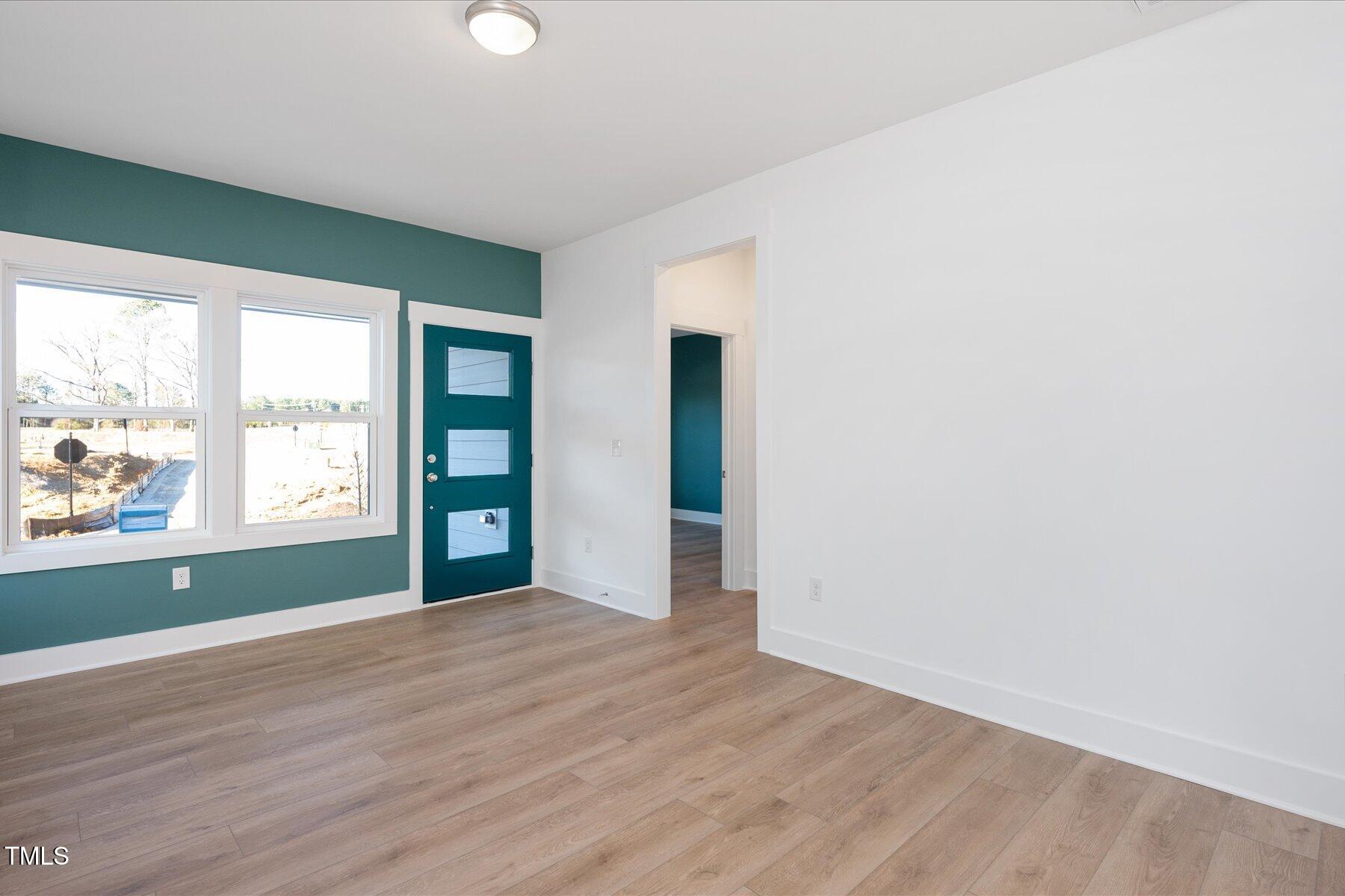 3939 Willow Gate Way Raleigh, NC 27604 - Photo 5 of 32 an empty room with wooden floor and windows