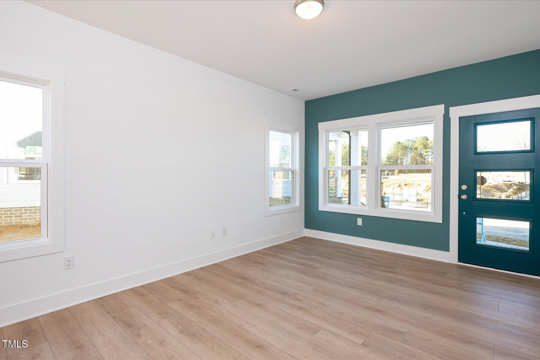3939 Willow Gate Way Raleigh, NC 27604 - Photo 6 of 32 an empty room with wooden floor and windows