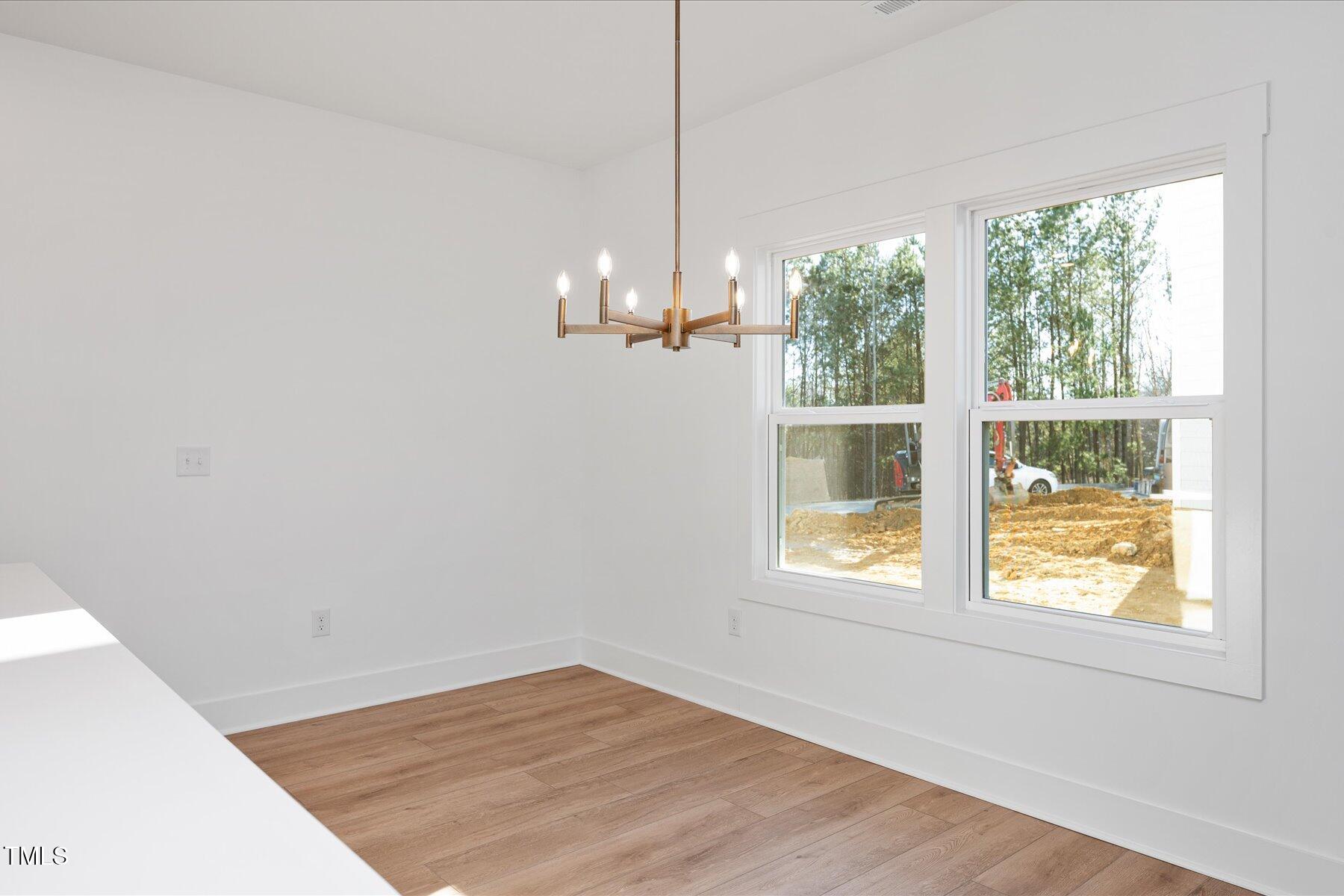 3939 Willow Gate Way Raleigh, NC 27604 - Photo 8 of 32 a view of empty room with wooden floor and fan