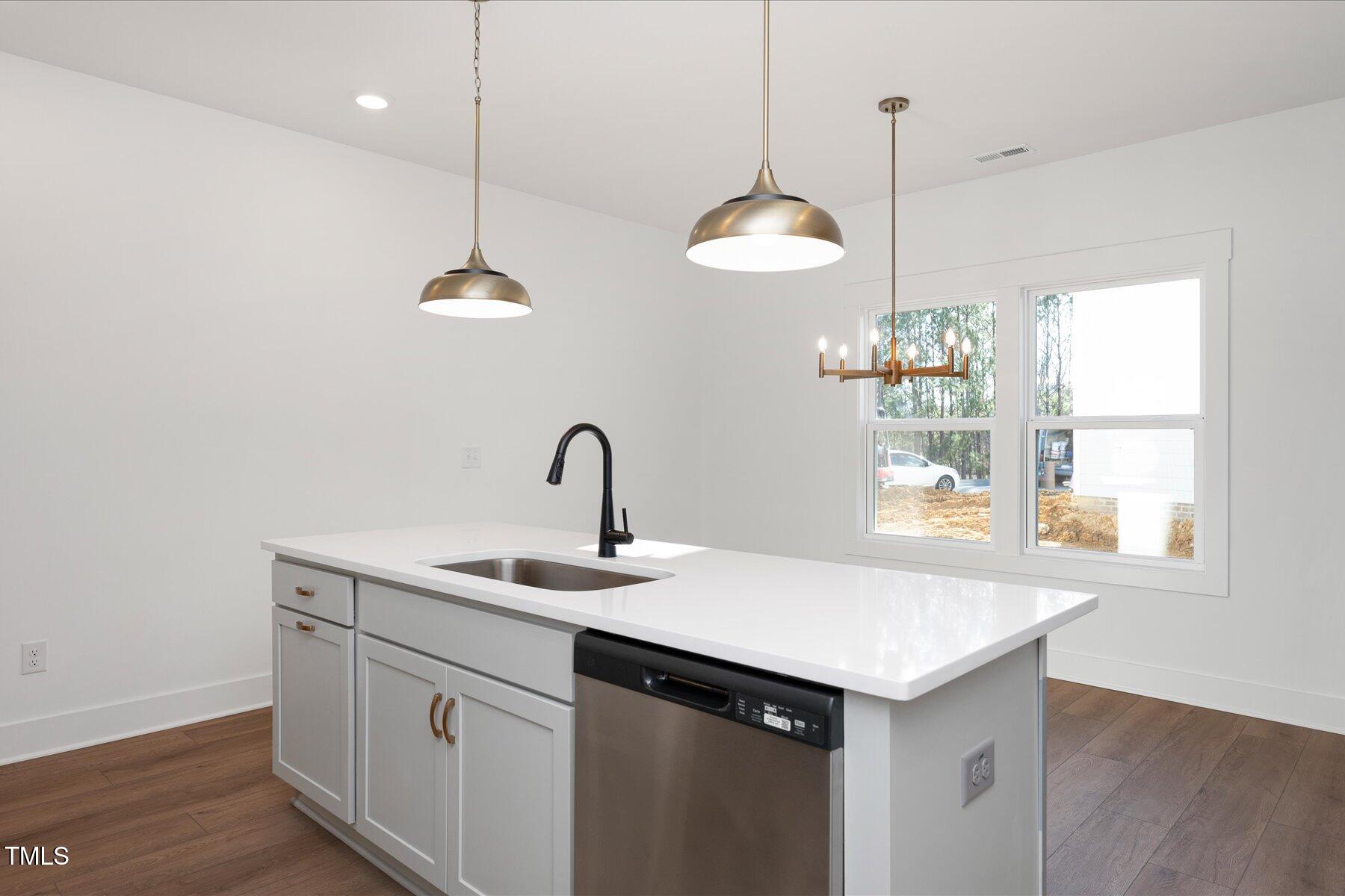 3939 Willow Gate Way Raleigh, NC 27604 - Photo 10 of 32 a kitchen that has a sink a counter space and a window