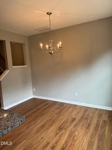 a view of a room with wooden floor