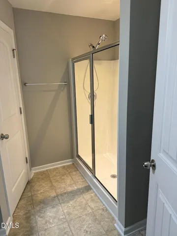 a bathroom with a glass shower door