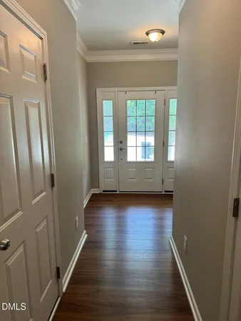 a view of wooden floor and windows in a room