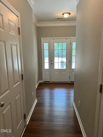 a view of wooden floor and windows in a room
