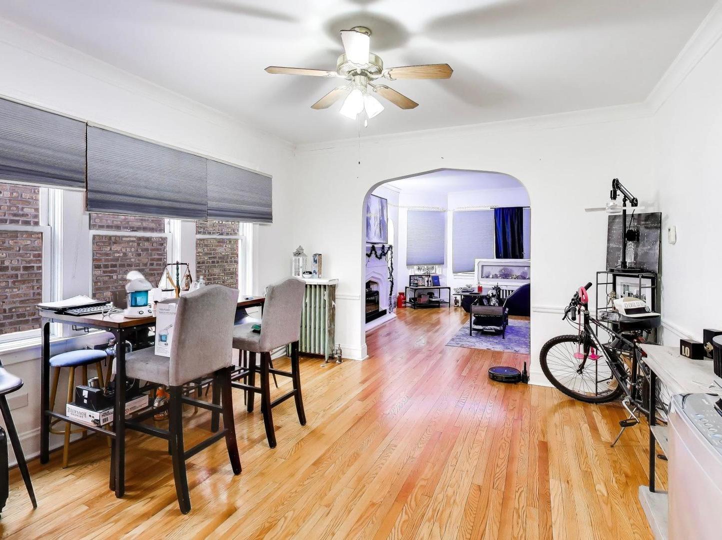 8322 South Sangamon Street Chicago, IL 60620 - Photo 16 of 36 a view of a dining room and livingroom with furniture wooden floor a chandelier