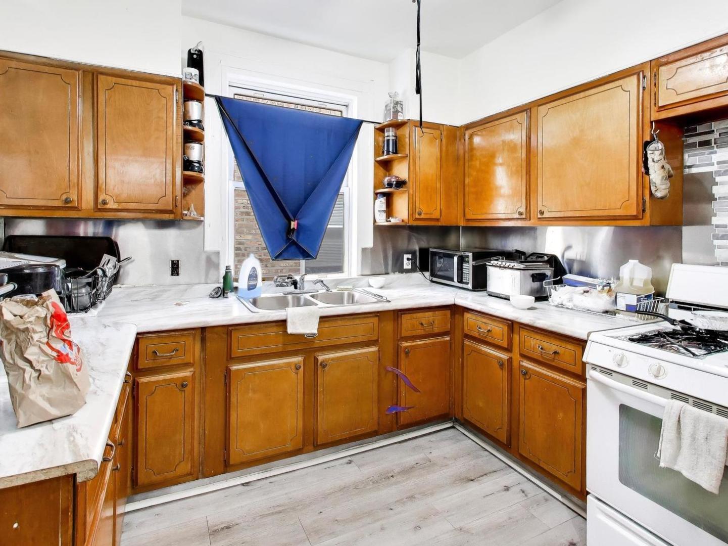 8322 South Sangamon Street Chicago, IL 60620 - Photo 19 of 36 a kitchen with stainless steel appliances granite countertop a sink stove and cabinets