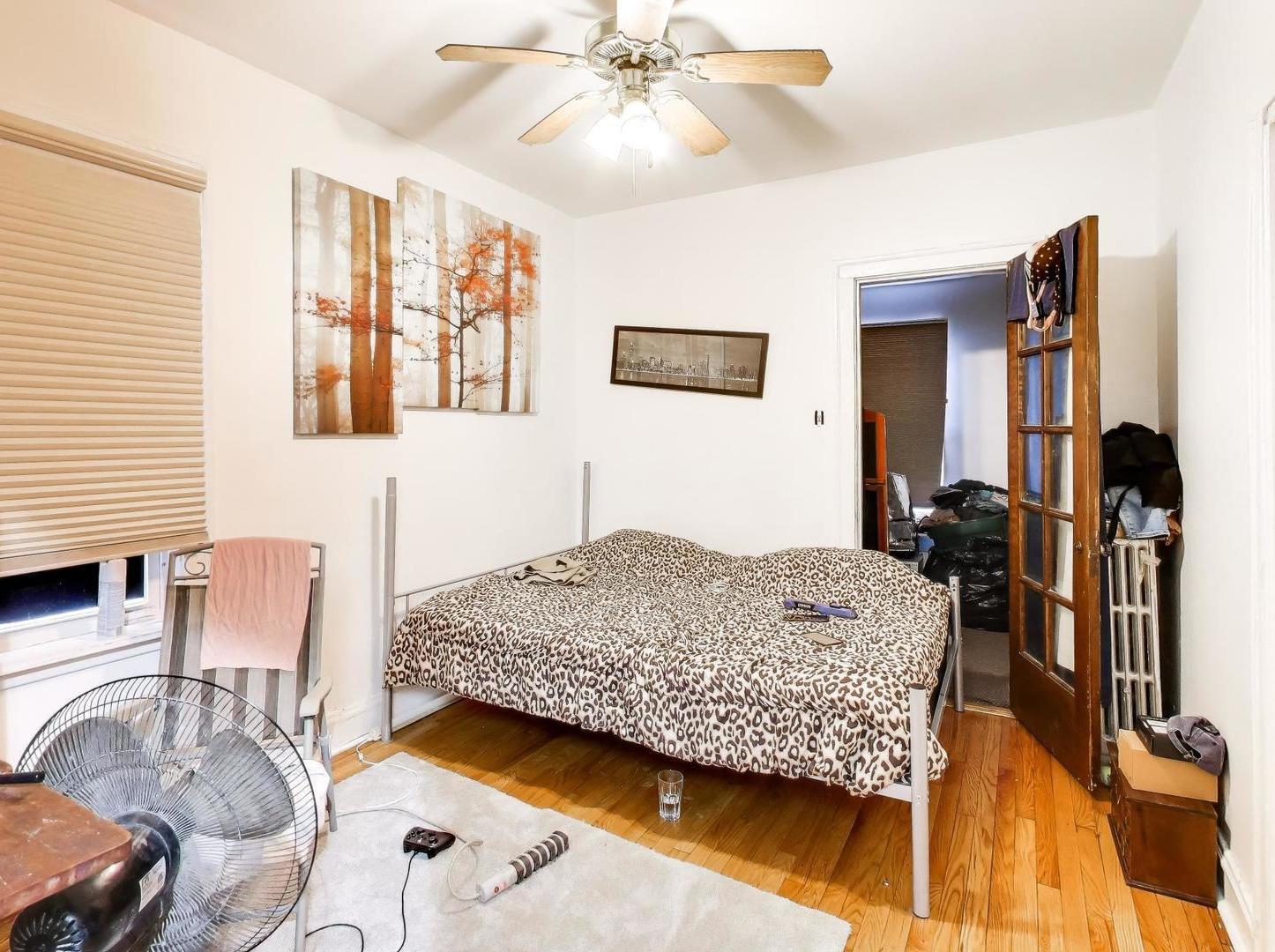 8322 South Sangamon Street Chicago, IL 60620 - Photo 20 of 36 a bedroom with bed and a chandelier