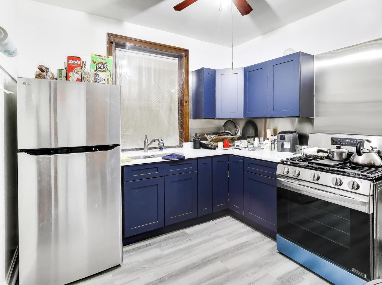 8322 South Sangamon Street Chicago, IL 60620 - Photo 26 of 36 a kitchen with a refrigerator and cabinets