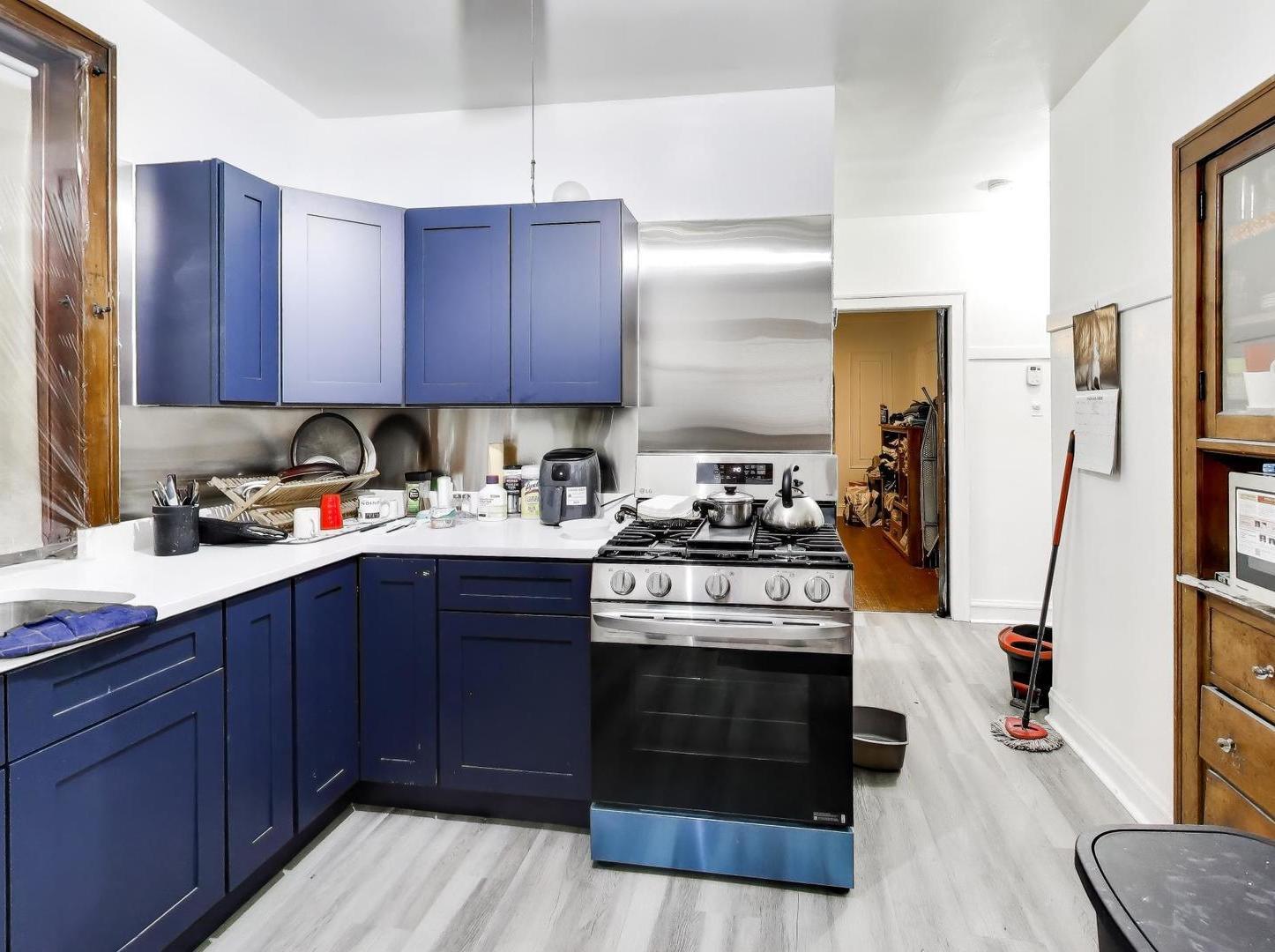 8322 South Sangamon Street Chicago, IL 60620 - Photo 27 of 36 a kitchen with stainless steel appliances granite countertop a stove a sink dishwasher and a refrigerator with wooden cabinets