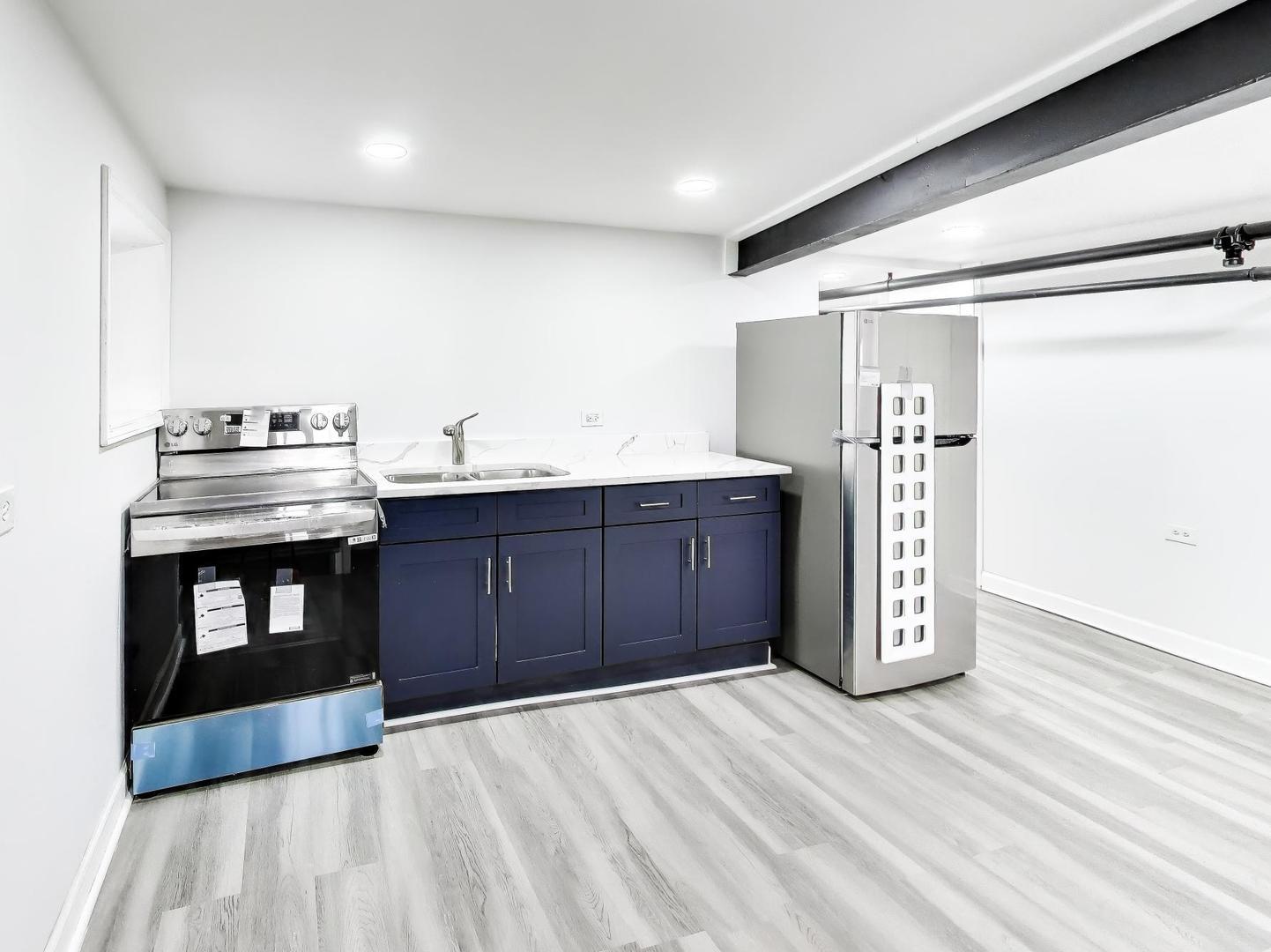8322 South Sangamon Street Chicago, IL 60620 - Photo 3 of 36 a kitchen with stainless steel appliances granite countertop a stove and a refrigerator
