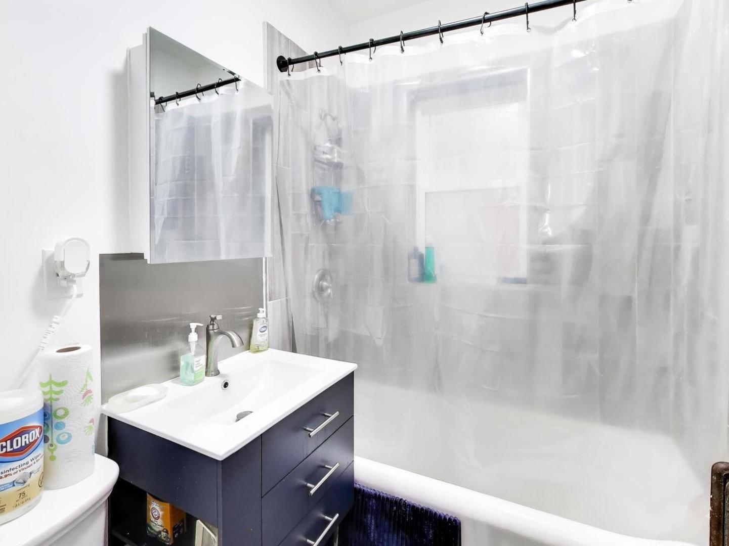8322 South Sangamon Street Chicago, IL 60620 - Photo 31 of 36 a bathroom with a sink mirror and a shower
