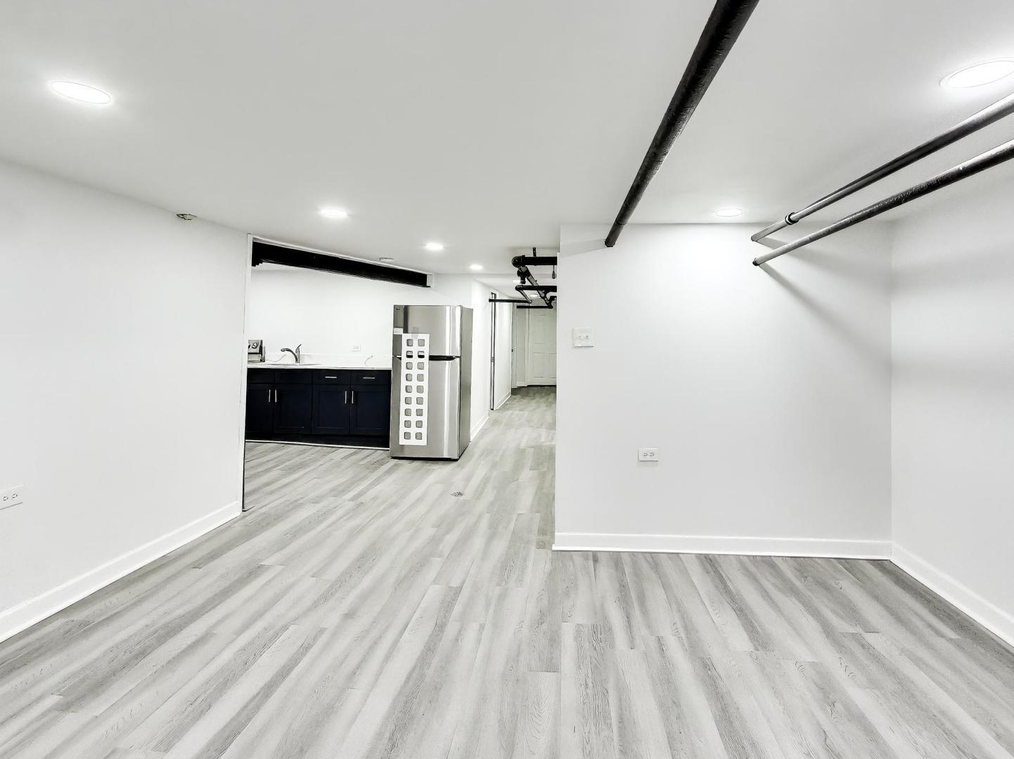 8322 South Sangamon Street Chicago, IL 60620 - Photo 5 of 36 a view of empty room with wooden floor