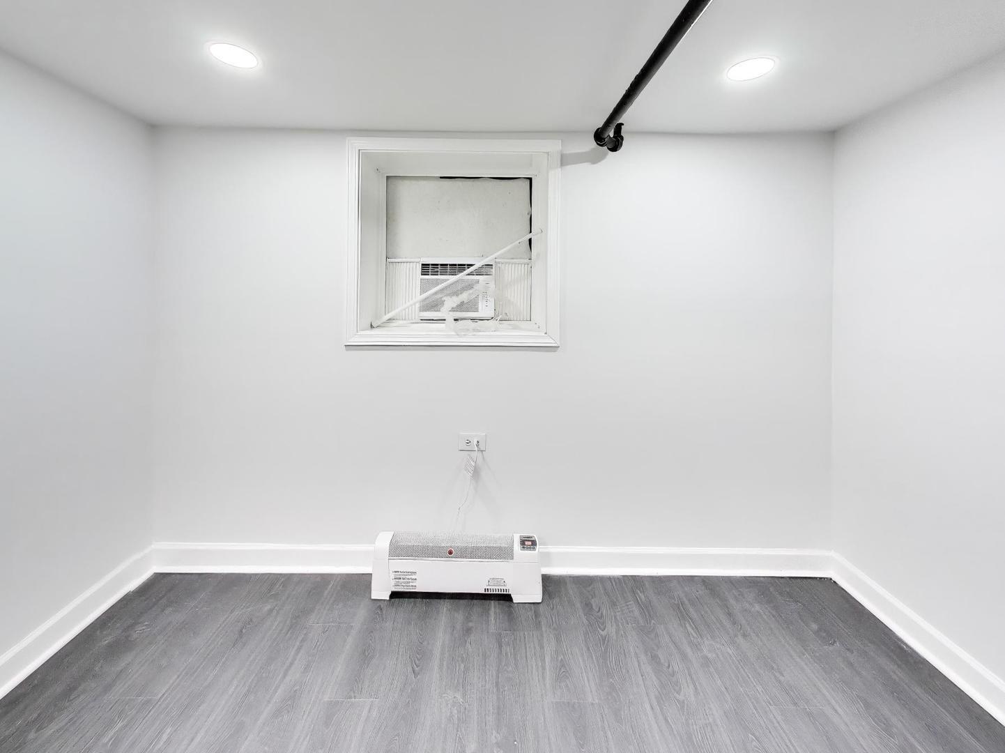 8322 South Sangamon Street Chicago, IL 60620 - Photo 8 of 36 an empty room with wooden floor and bench