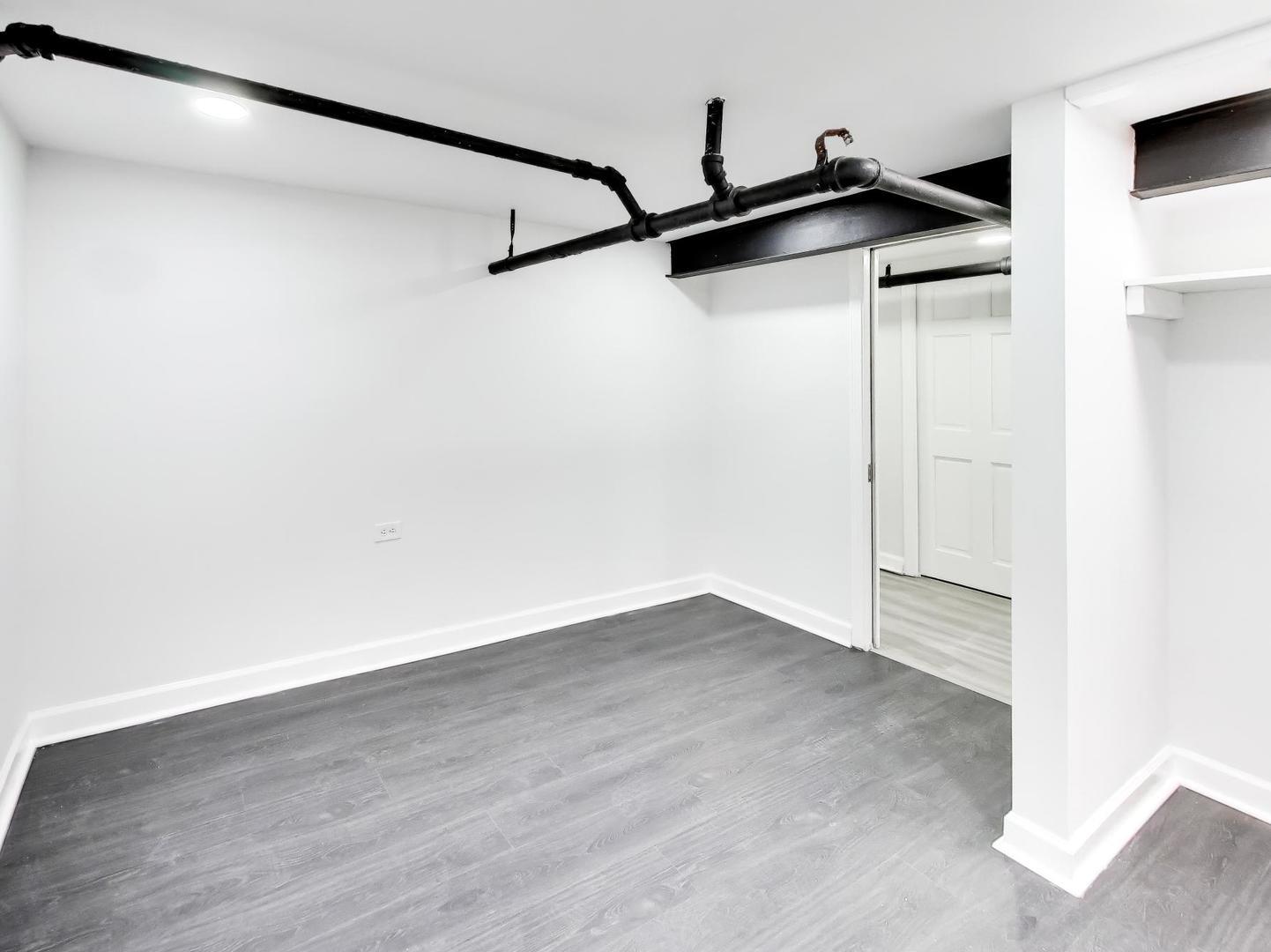 8322 South Sangamon Street Chicago, IL 60620 - Photo 9 of 36 a view of a room with wooden floor and wooden floor