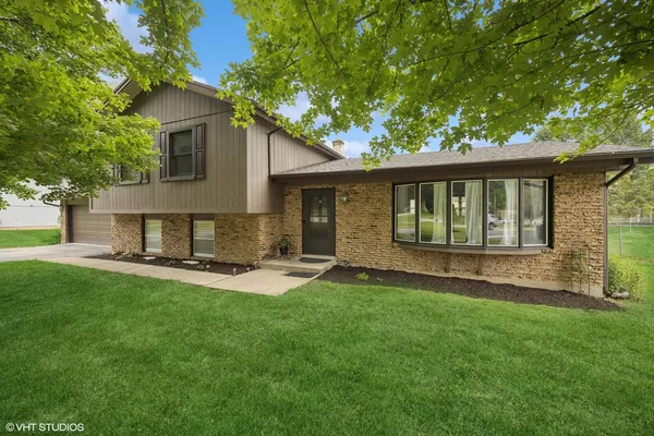 a front view of house with yard and outdoor seating