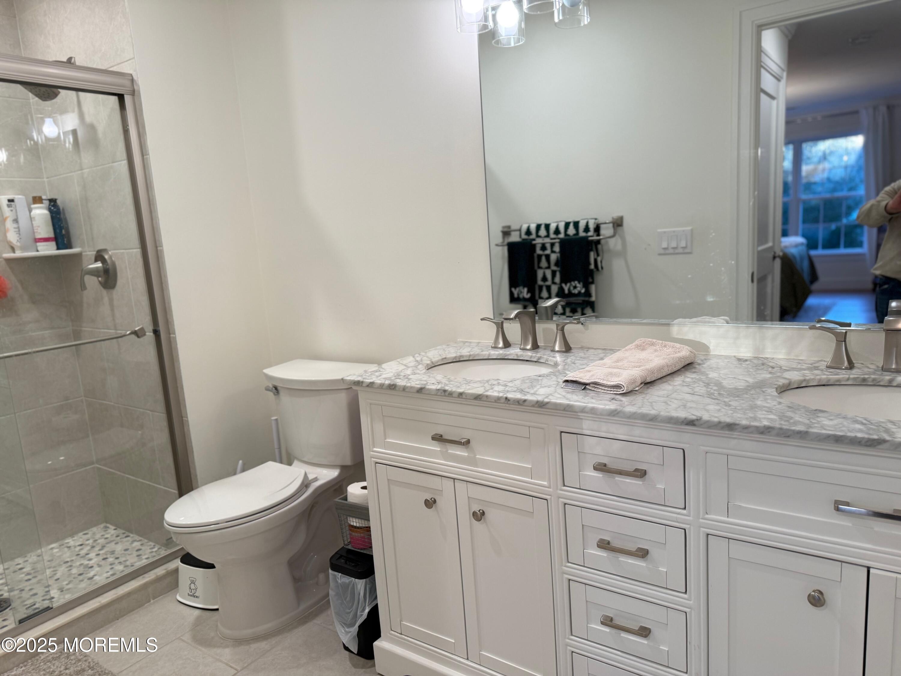 388 Deuce Drive Wall, NJ 07719 - Photo 24 of 38 a bathroom with a granite countertop toilet sink and a mirror