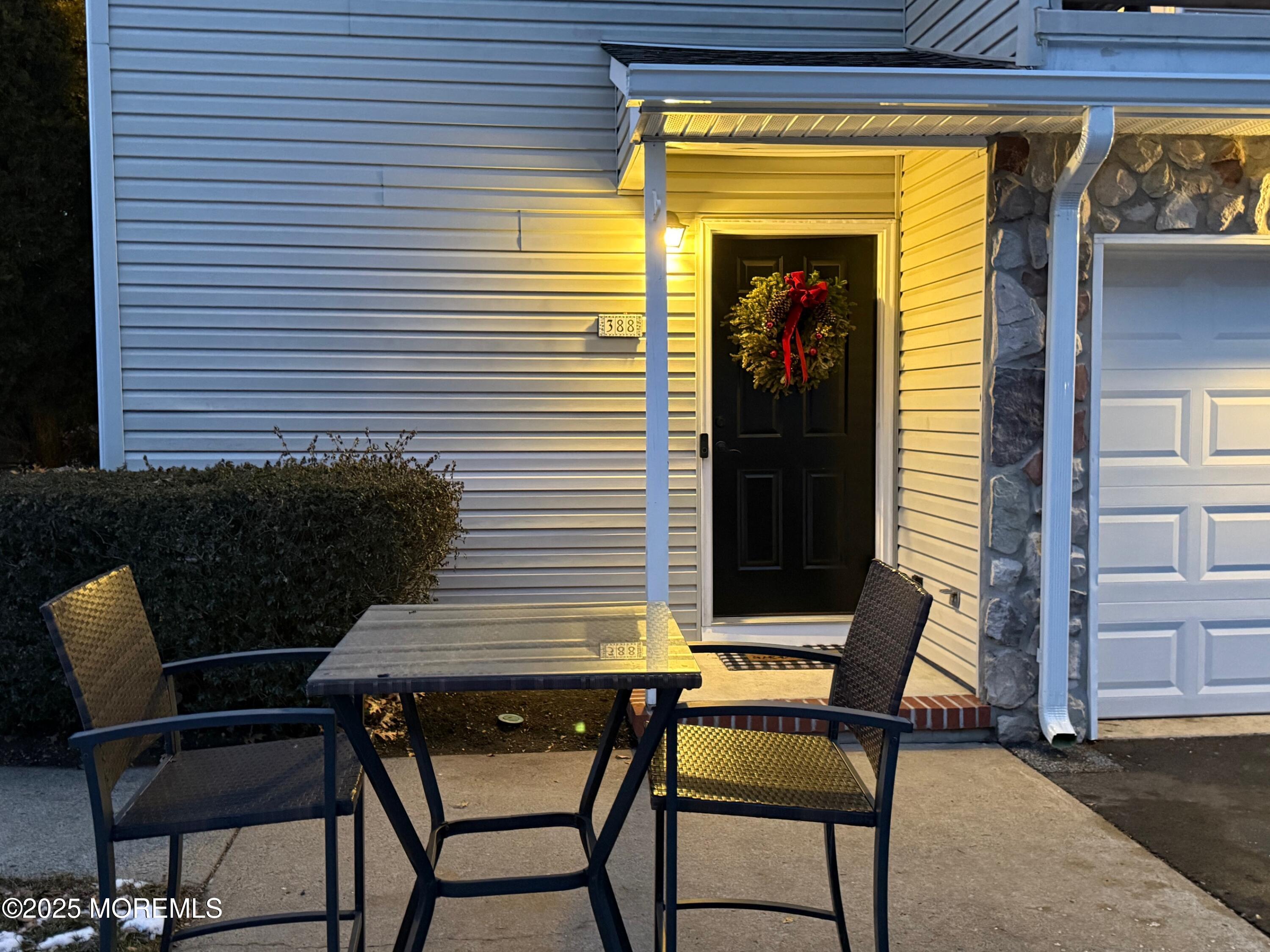 388 Deuce Drive Wall, NJ 07719 - Photo 3 of 38 a view of a patio with a table and chairs and potted plants