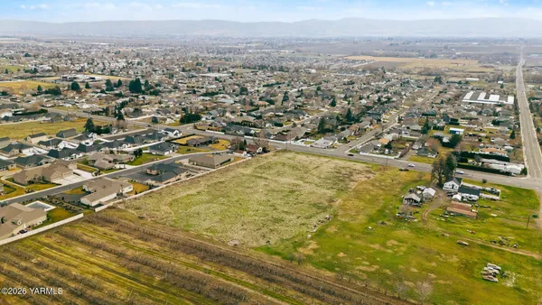 an aerial view of residential houses with city view