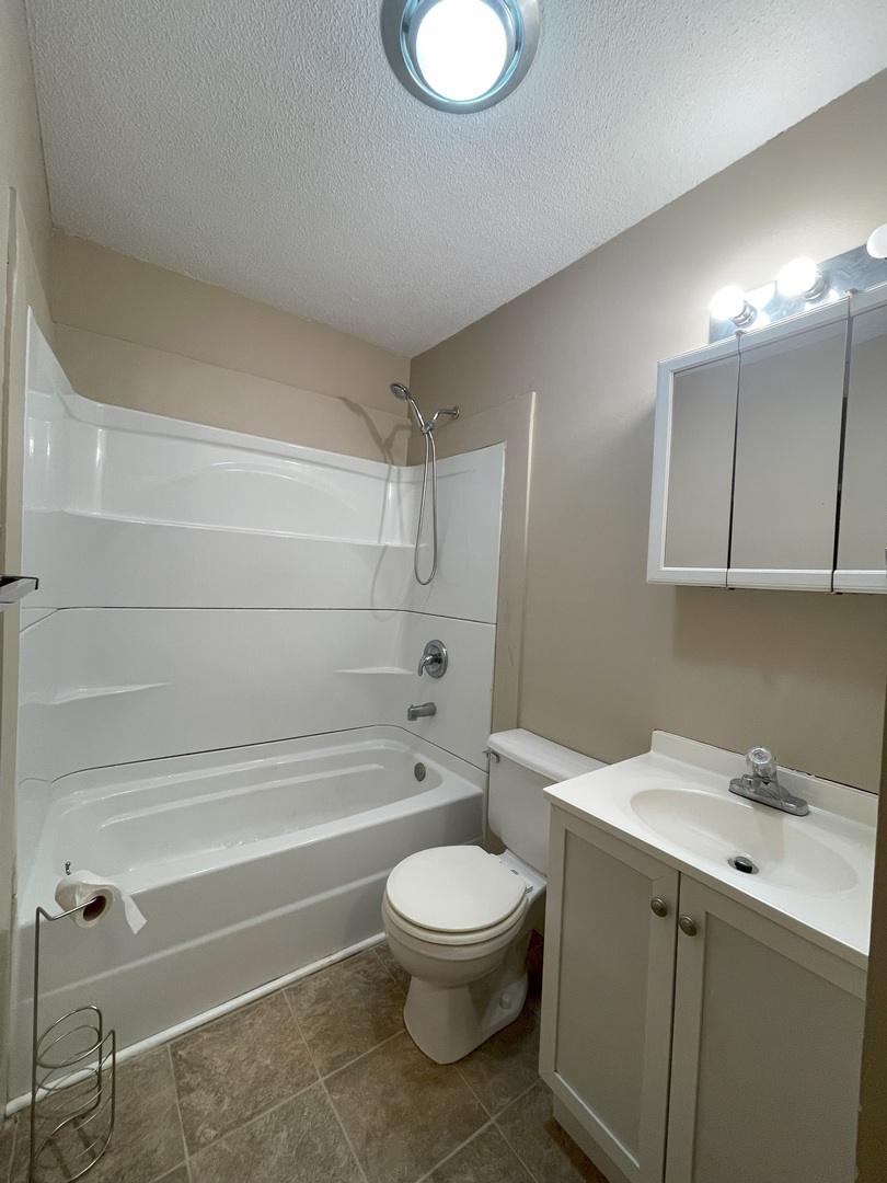17 Circle Drive Saybrook, IL 61770 - Photo 14 of 17 a bathroom with a toilet a sink and bathtub