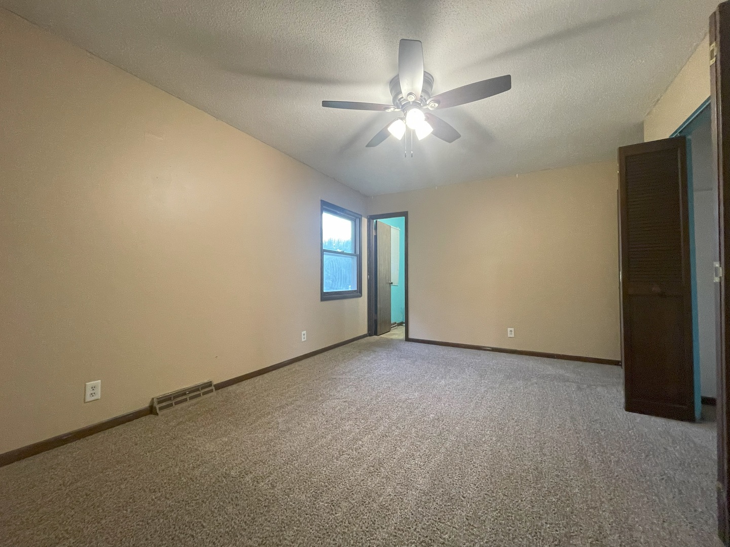 17 Circle Drive Saybrook, IL 61770 - Photo 8 of 17 an empty room with chandelier fan and windows
