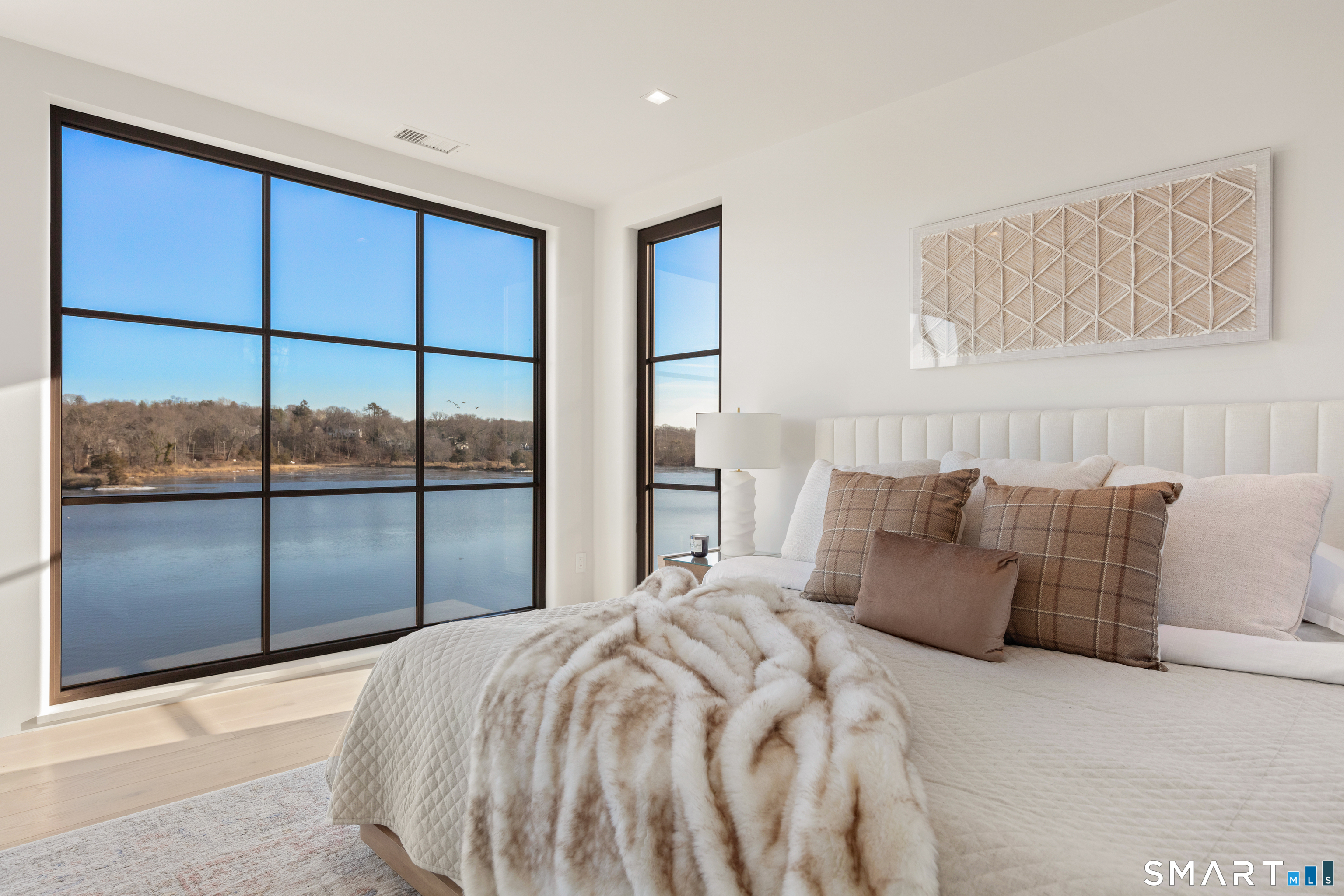 79 Riverside Avenue Westport, CT 06880 - Photo 13 of 40 a bedroom with a large bed and a large window