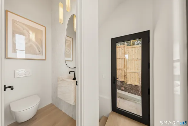 a bathroom with a toilet and a shower